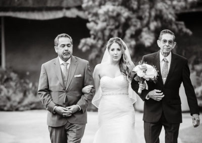 bride walking down the aisle with fathers