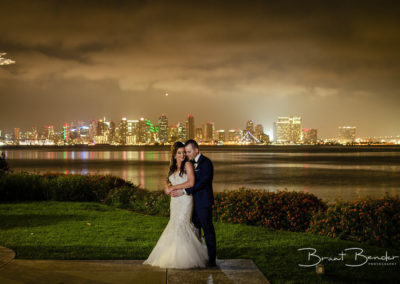 american bride and groom in front of skyline