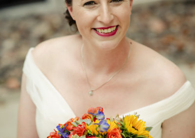 smiling bride with colorful bouquet
