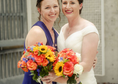 bride and bridesmaid smiling