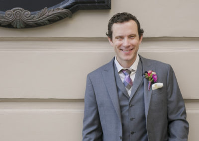 groom smiling grey suit brant bender photography
