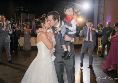 cute bride and groom and kids kiss brant bender photography