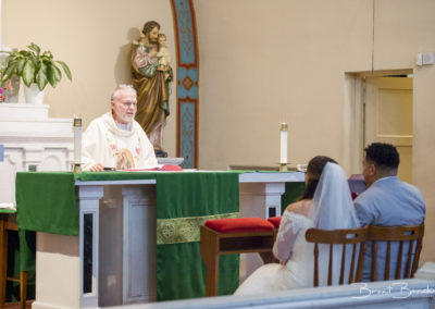 catholic church wedding ceremony bride and groom listening to priest